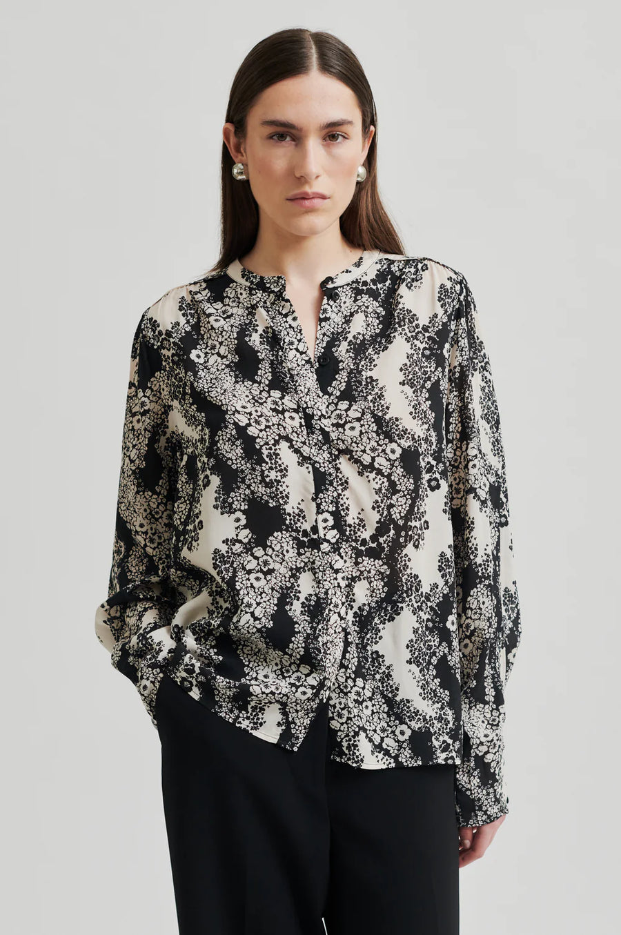 Black and cream floral print shirt with  placket with concealed button fastening and top visible button.