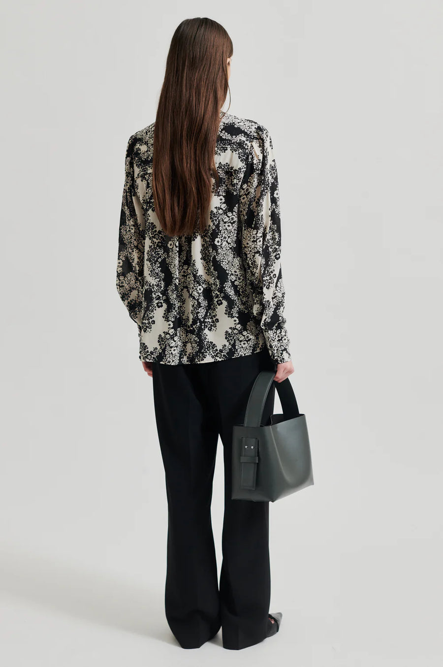 Black and cream floral print shirt with  placket with concealed button fastening and top visible button.