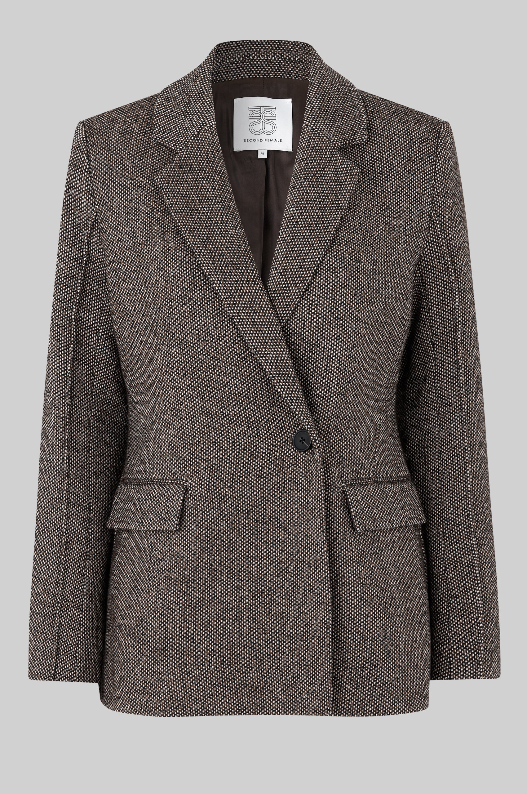 Brown blazer with a brand label on a gray background