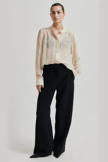 Mid waist wide leg pants in black with plated front. 