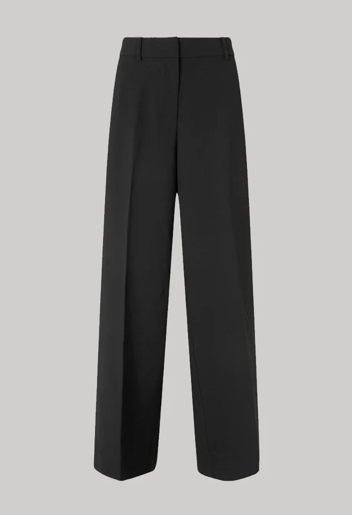 Mid waist wide leg pants in black with plated front. 