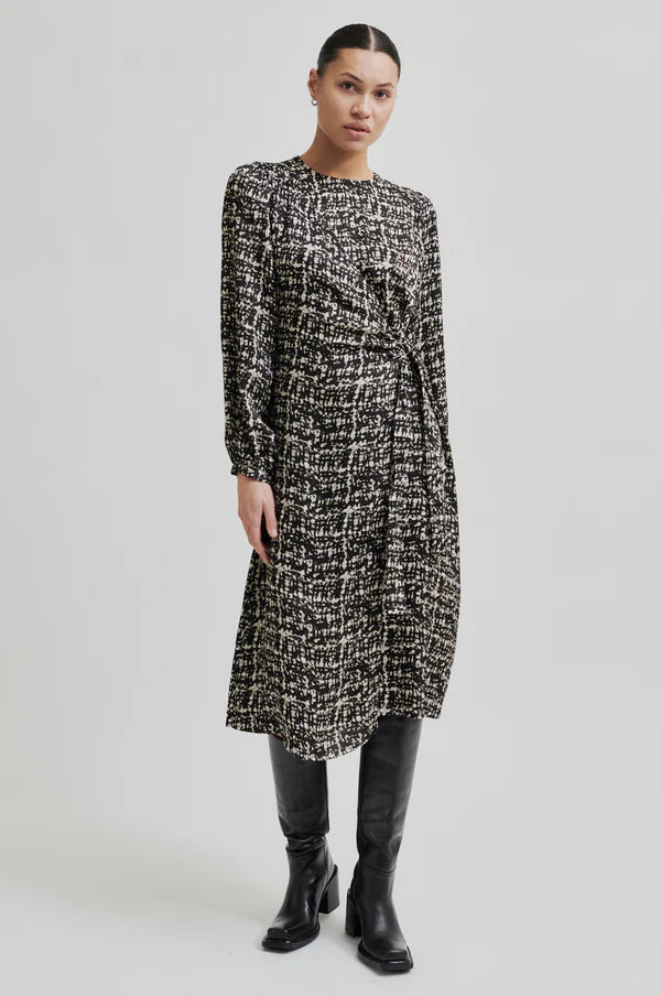 Monochrome long sleeve dress with crossover front that ties to one side. 