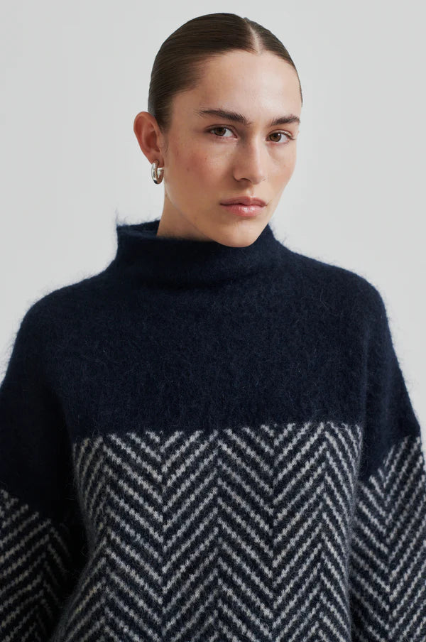 Chevron patterned turtle-neck pullover in Navy and Cream.