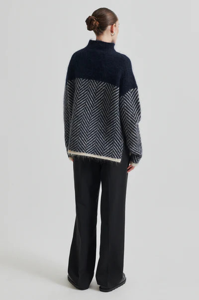 Chevron patterned turtle-neck pullover in Navy and Cream.