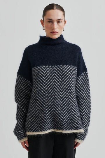 Chevron patterned turtle-neck pullover in Navy and Cream.