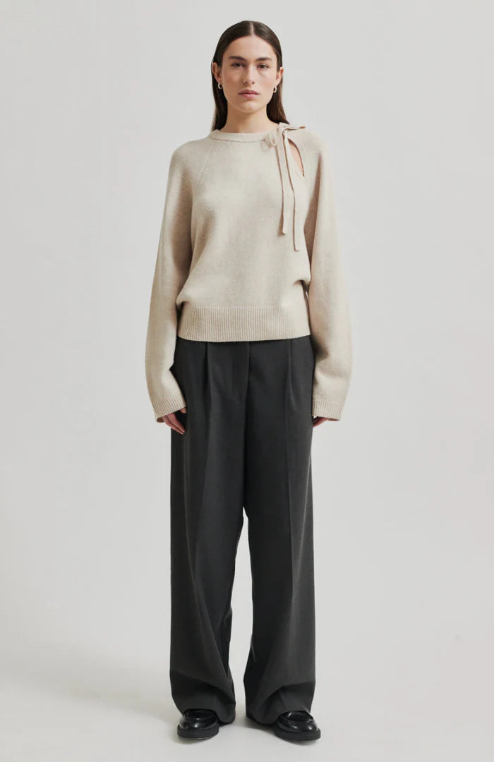 Long sleeve Pumice Colour sweater with slight oversize fit and bow detail at top left shoulder. 