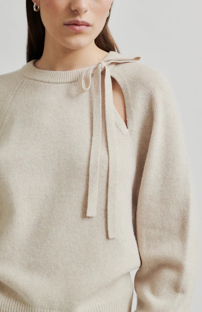 Long sleeve Pumice Colour sweater with slight oversize fit and bow detail at top left shoulder up close. 