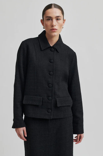 Tailored long sleeve black jacket with shirt collar, front pockets and covered buttons. 