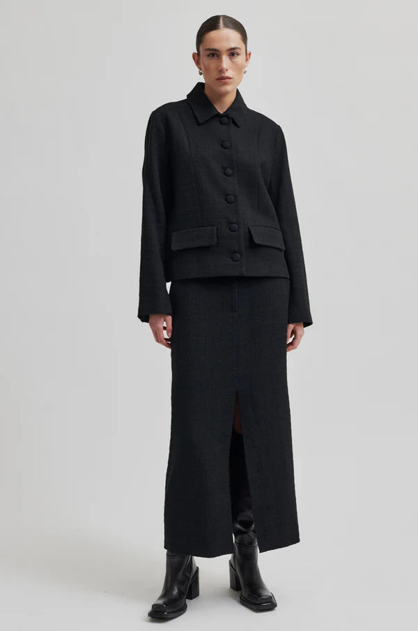 Long tailored black skirt with front slit. 