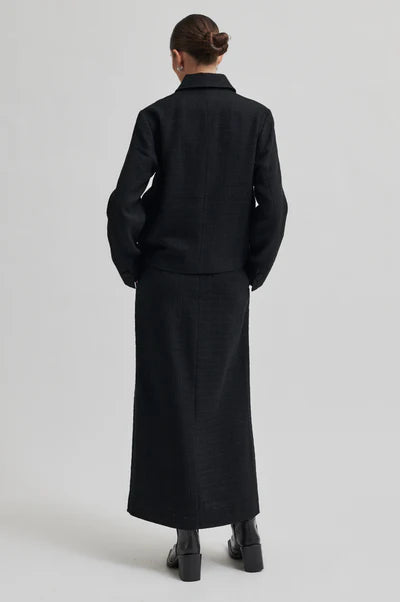 Long tailored black skirt with front slit. 