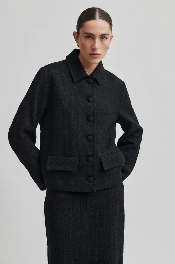 Long tailored black skirt with front slit. 