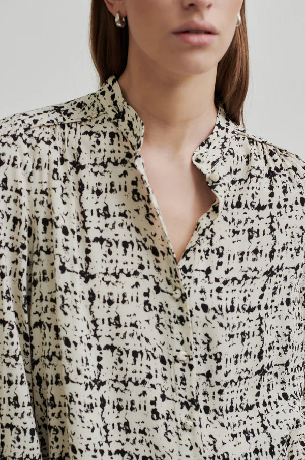 Long sleeve shirt with all over print in a cream base with black print. 