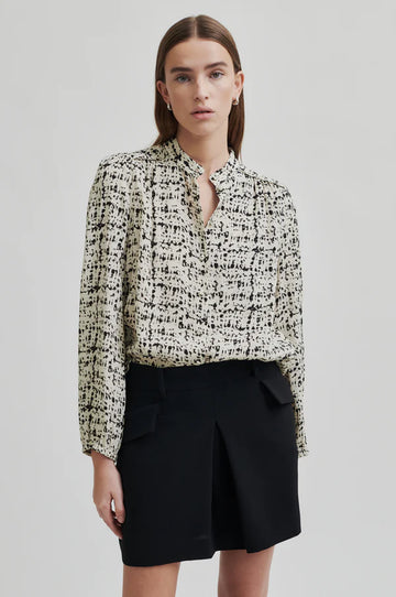 Long sleeve shirt with all over print in a cream base with black print. 