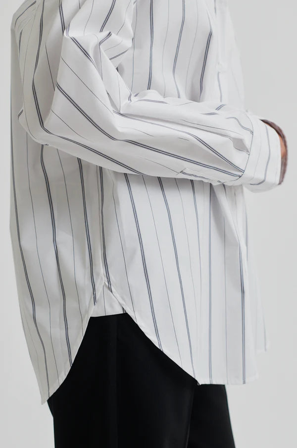White cotton shirt with black vertical stripes. Long sleeve and oversize fit. 