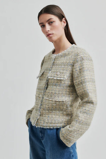 Boxy textured jacket with covered buttons and front pockets. 