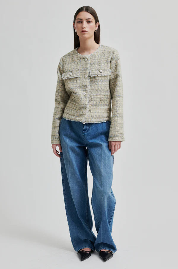 Boxy textured jacket with covered buttons and front pockets. 