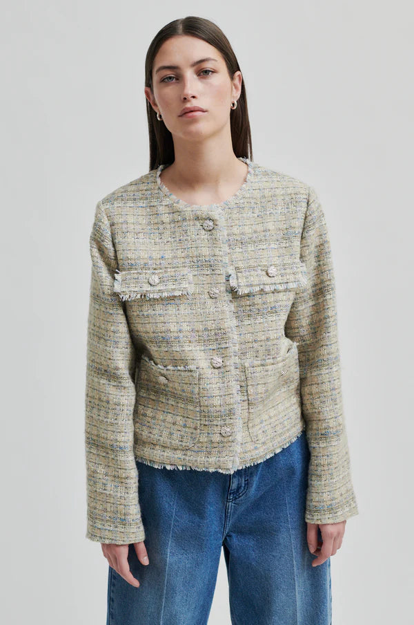 Boxy textured jacket with covered buttons and front pockets. 