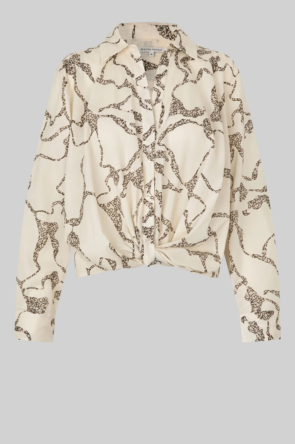 White blouse with brown pattern and twist front detail on a light  background