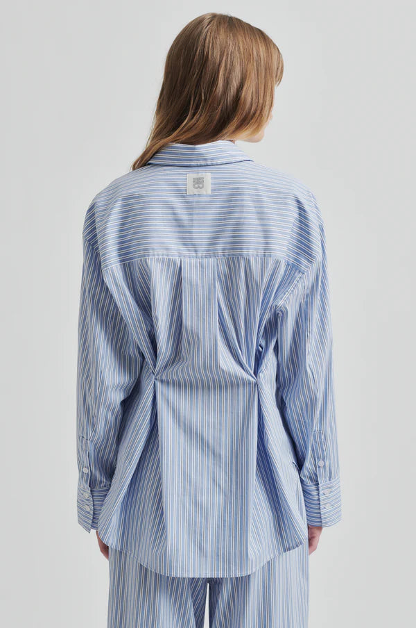 Model wearing a blue and white striped shirt back