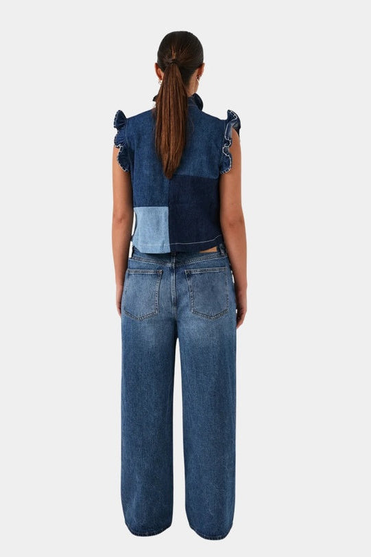 Person wearing a denim outfit with a white background