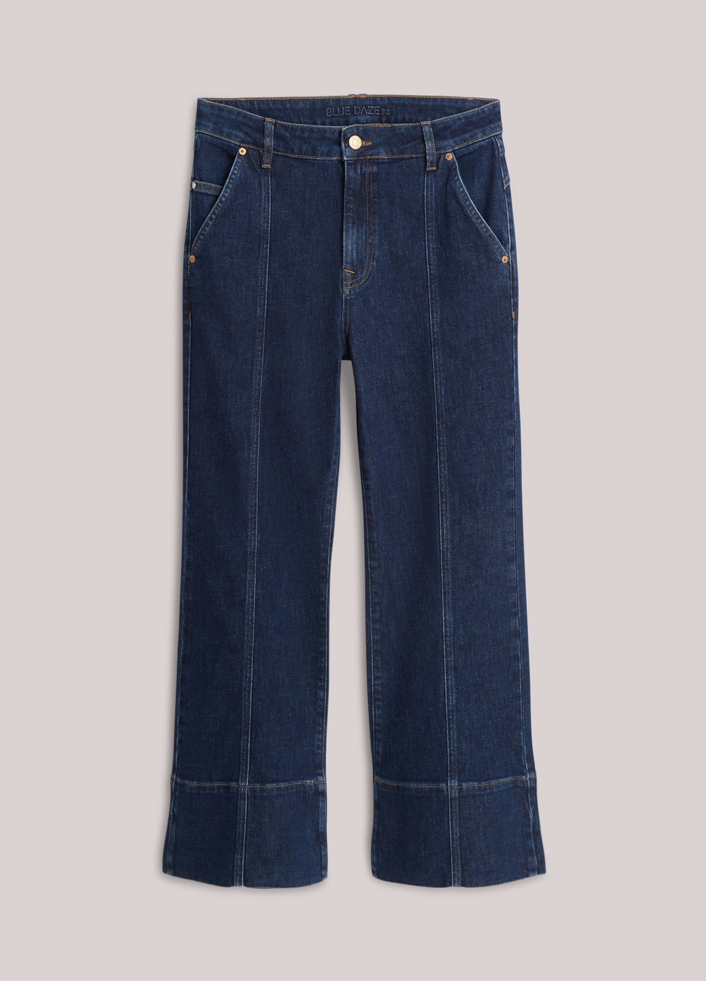 A pair of dark blue denim jeans with a wide leg and cuffed hems, displayed flat against a light beige background.