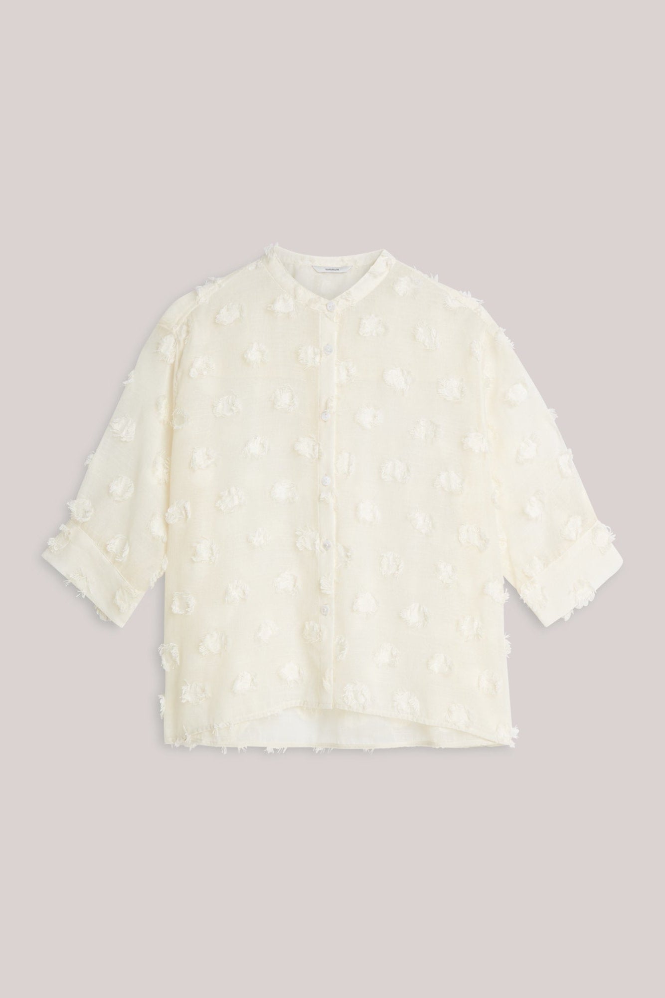 White blouse with lace details on a light  background