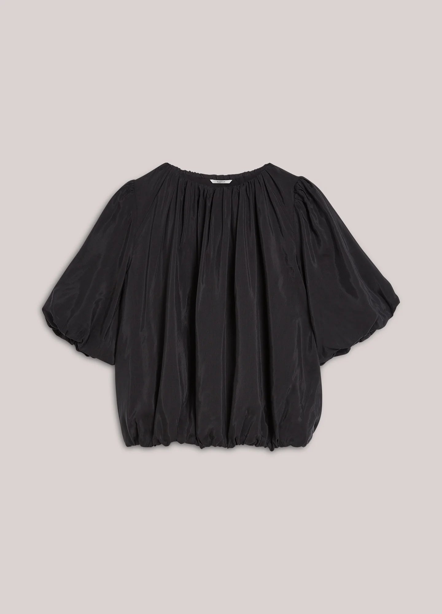 Black blouse with puff sleeves on a light background