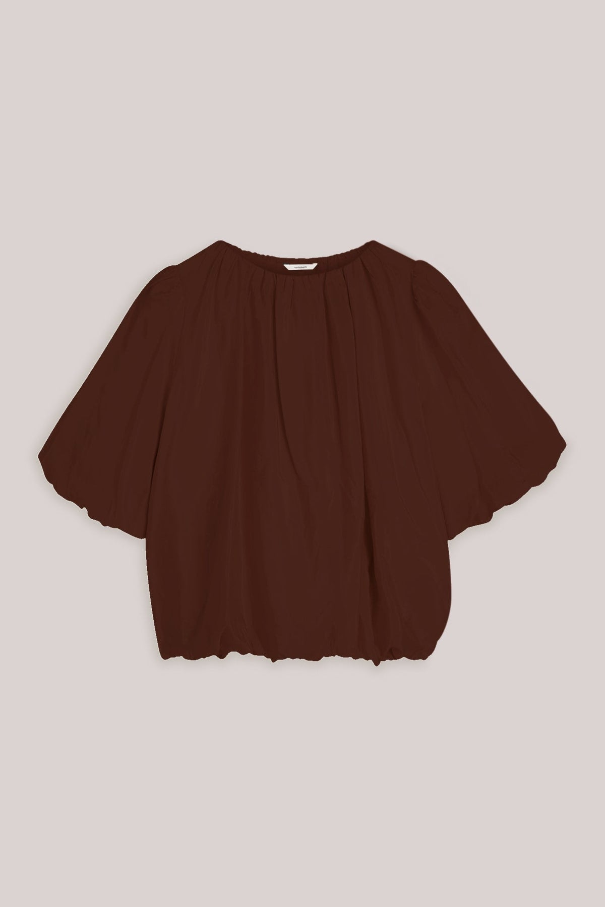 Brown blouse with short baloon sleeve on a light background