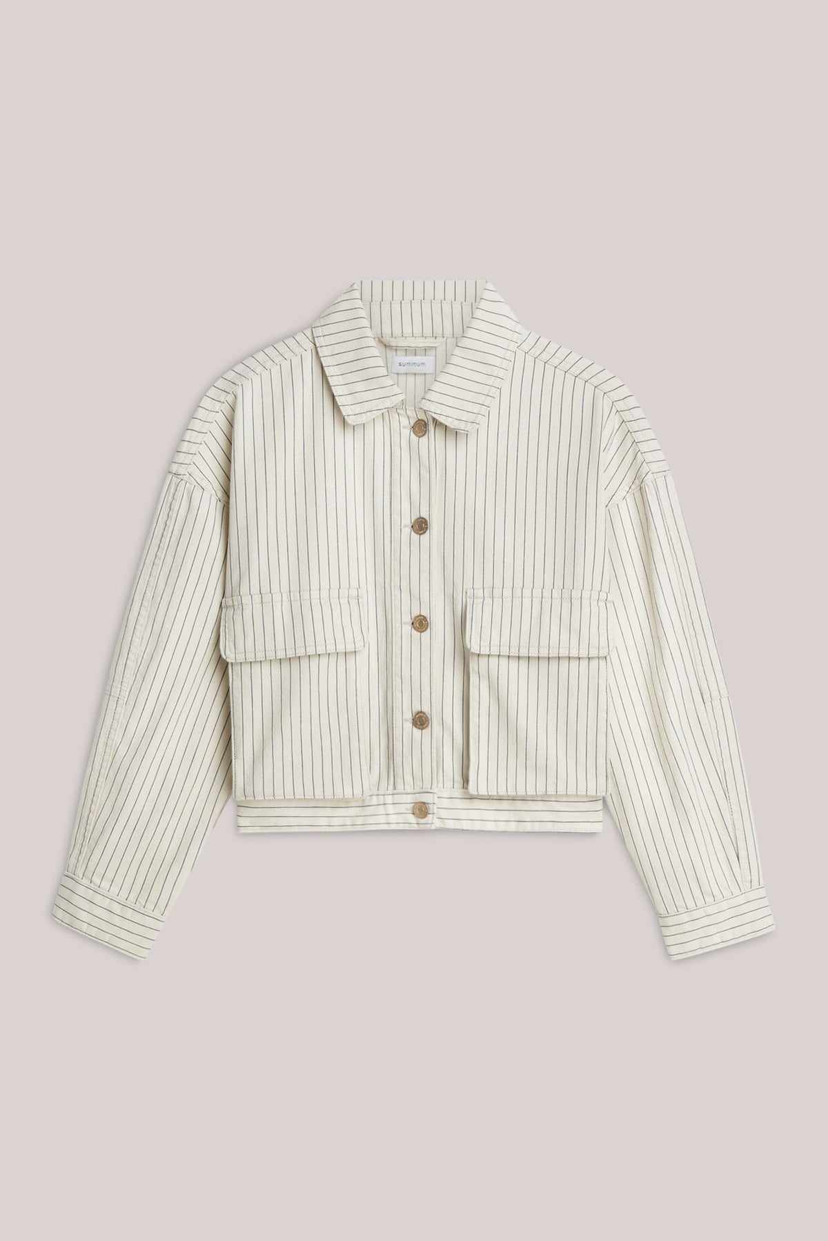 A cropped denim jacket wth an ivory base and navy herringbone vertical stripe detail on a plain background.  