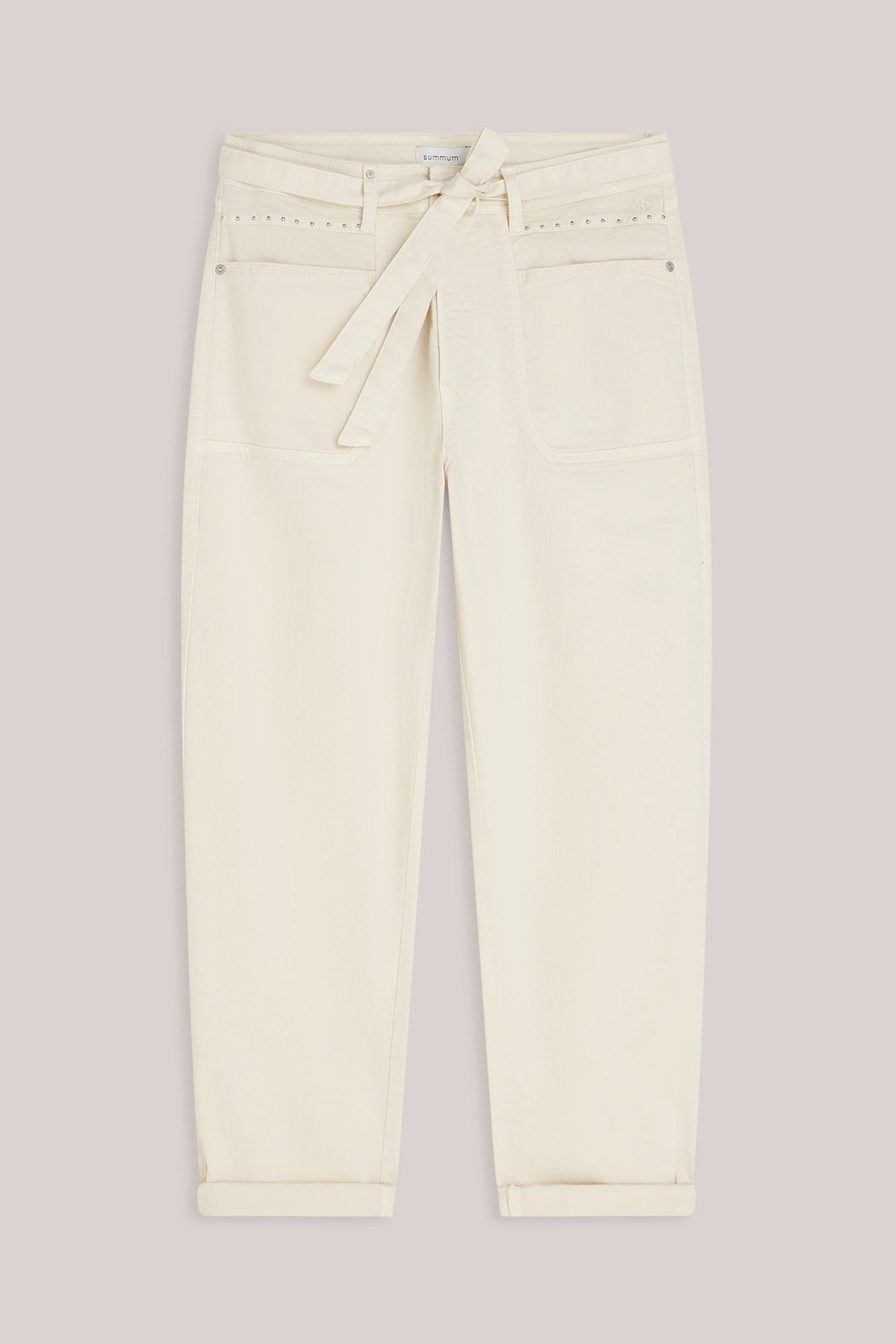 Cream-colored cropped jeans with a matching fabric tie belt at the waist, displayed flat against a solid light gray background.