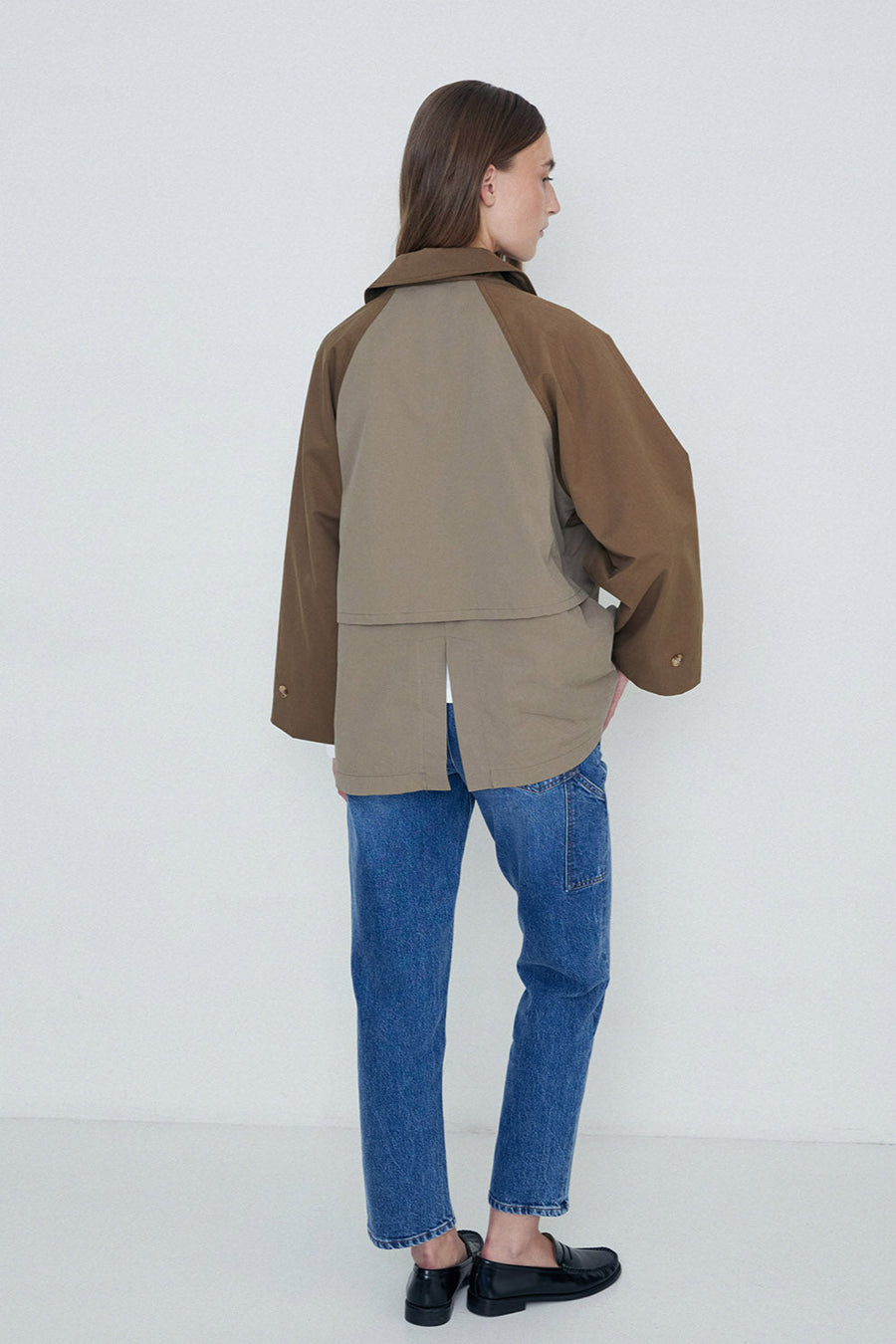 Khaki two tone double breasted short length trench coat back. 