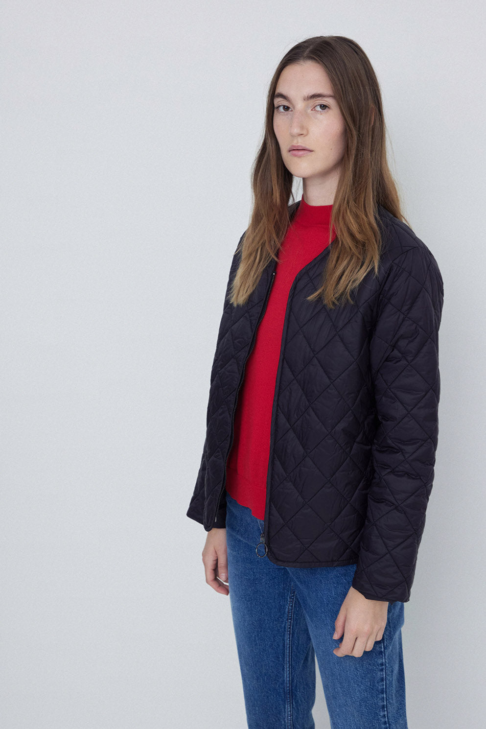 Black Long Sleeve Quilted Jacket with front zip. 