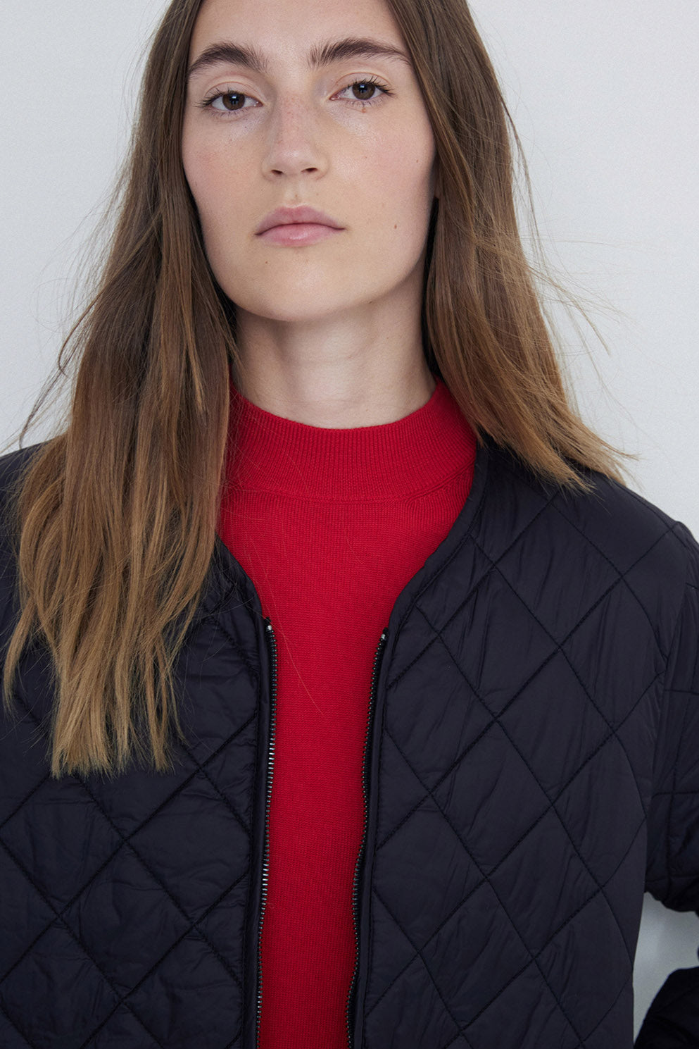 Black Long Sleeve Quilted Jacket with front zip. 