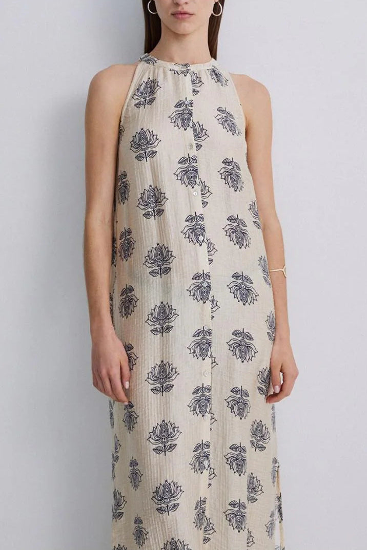 Women wearing a maxi dress with a cream base and blue floral print. 