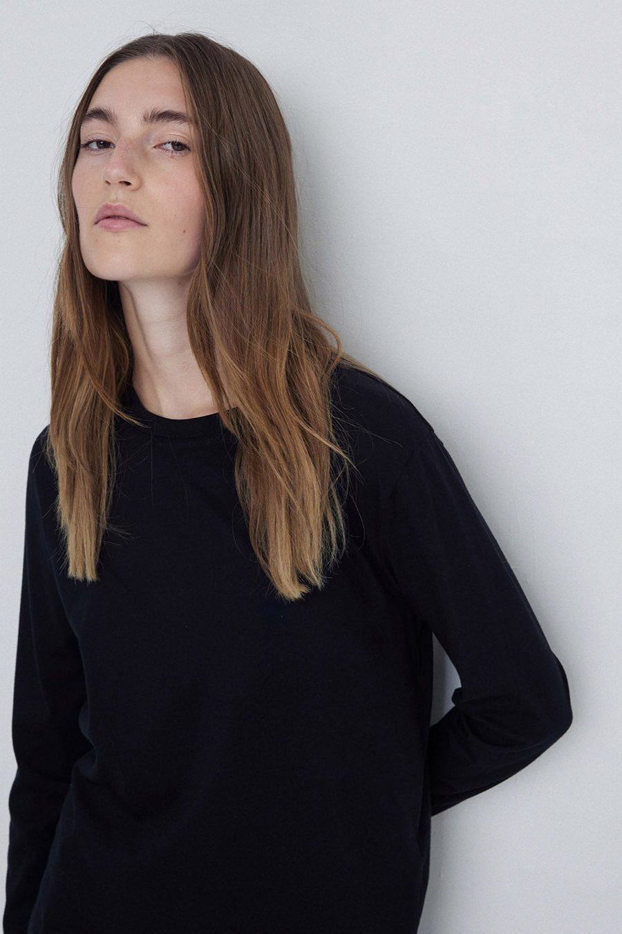 Black round neck long sleeve tee back close up. 