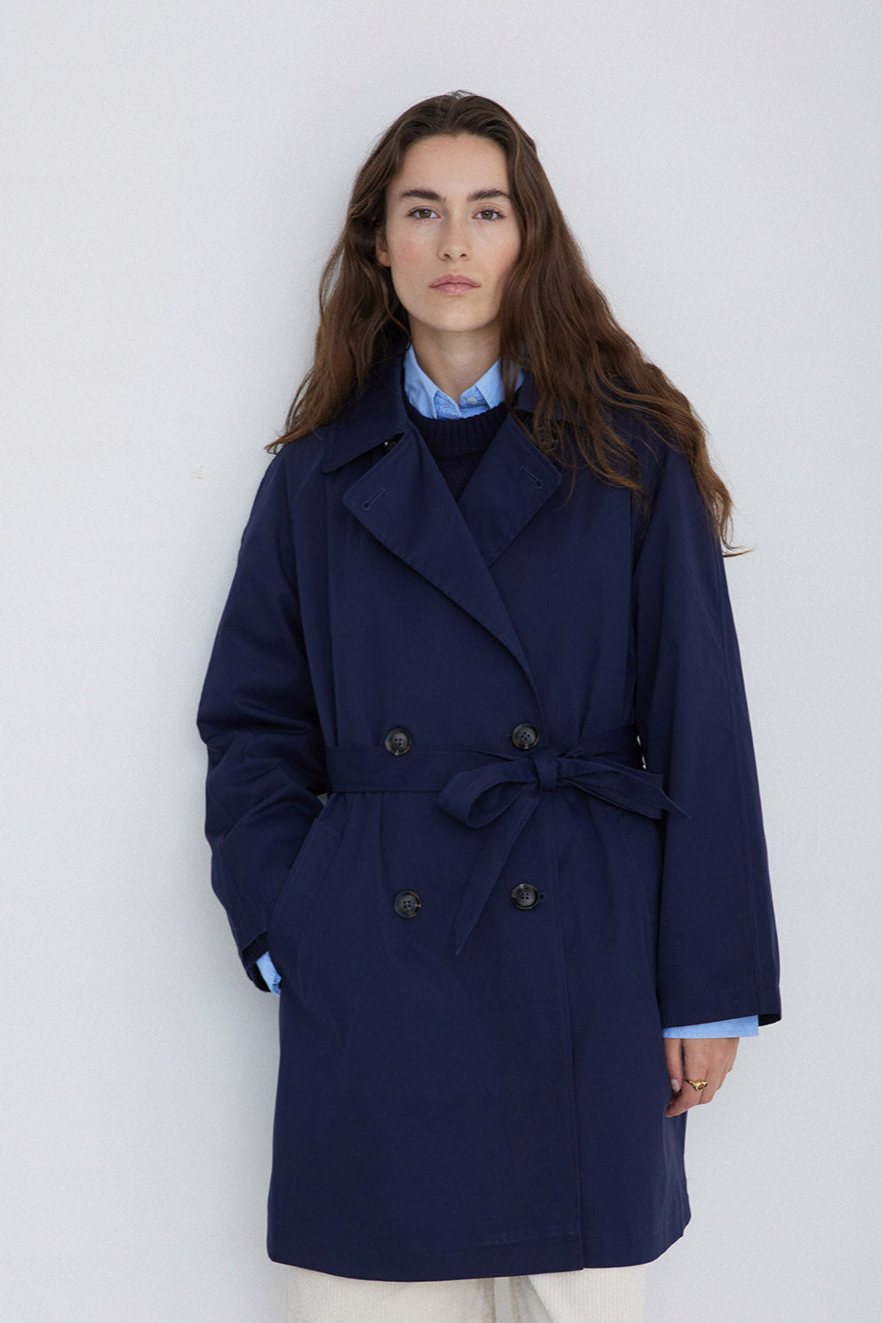Navy midi length double breasted trench coat with wide belt. 