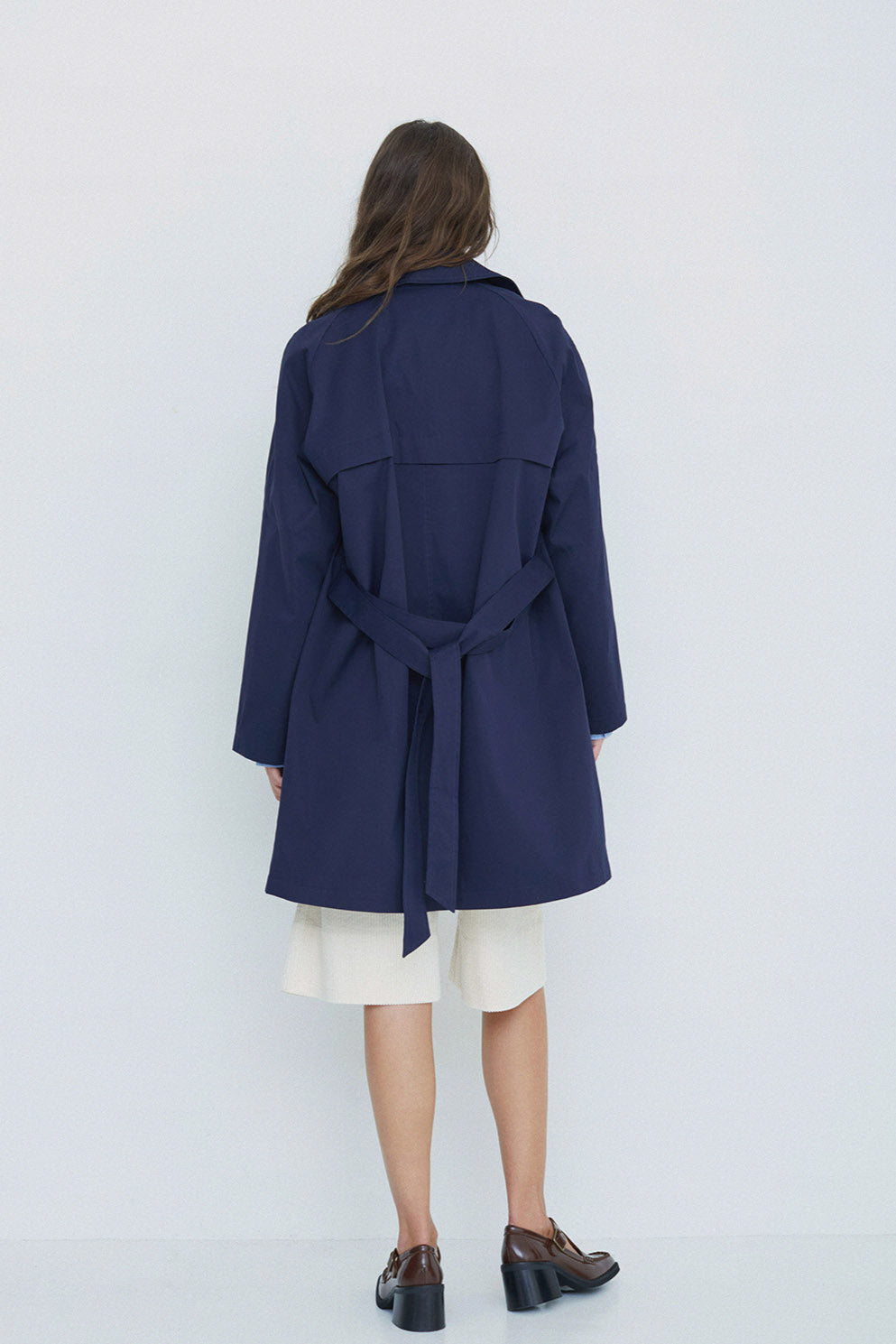 Navy midi length double breasted trench coat with wide belt - back. 