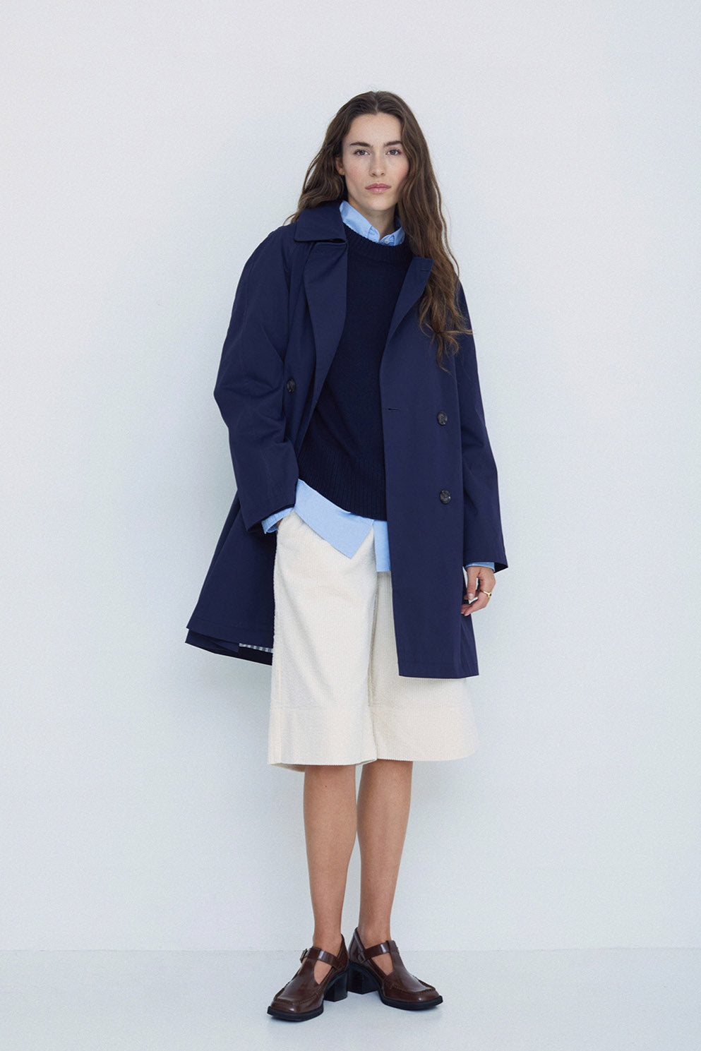 Navy midi length double breasted trench coat with wide belt. 