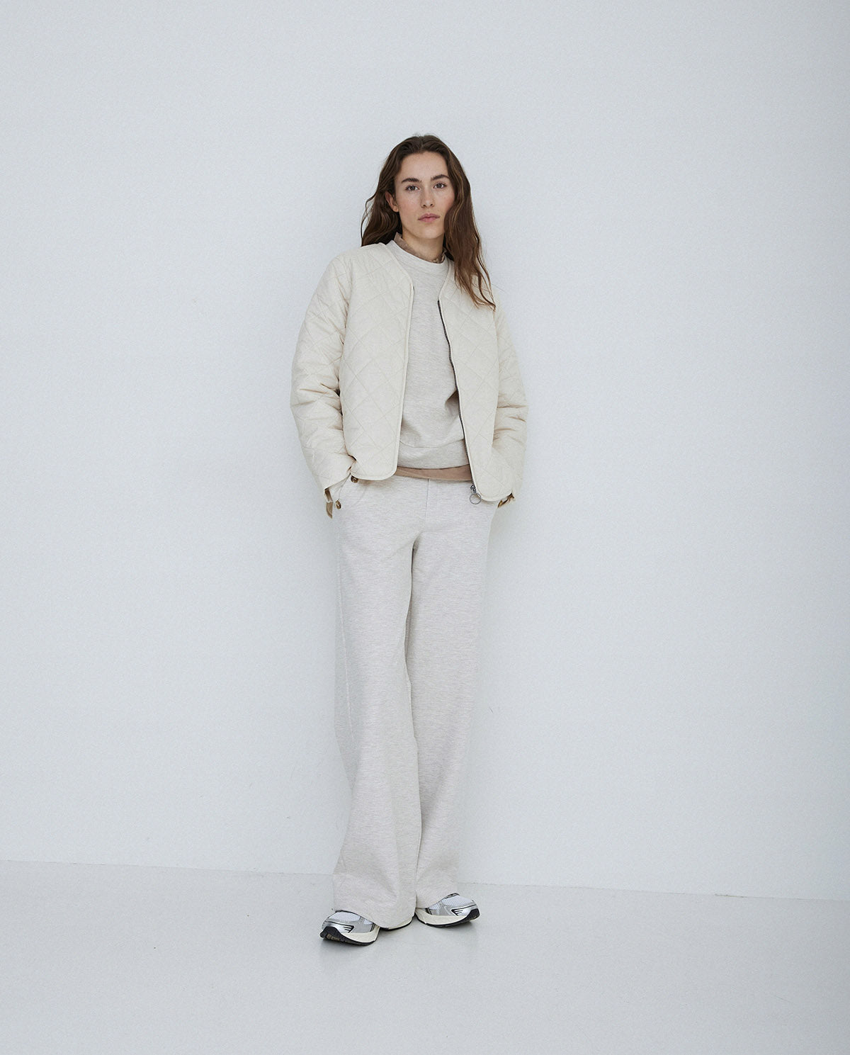 Long sleeve quilted jacket with front zip in natural colour way. 
