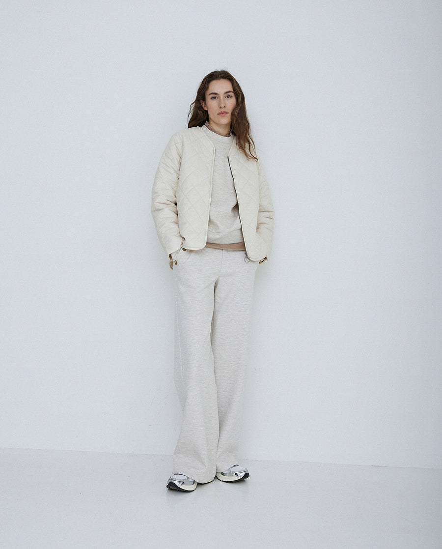 Long sleeve quilted jacket with front zip in natural colour way. 