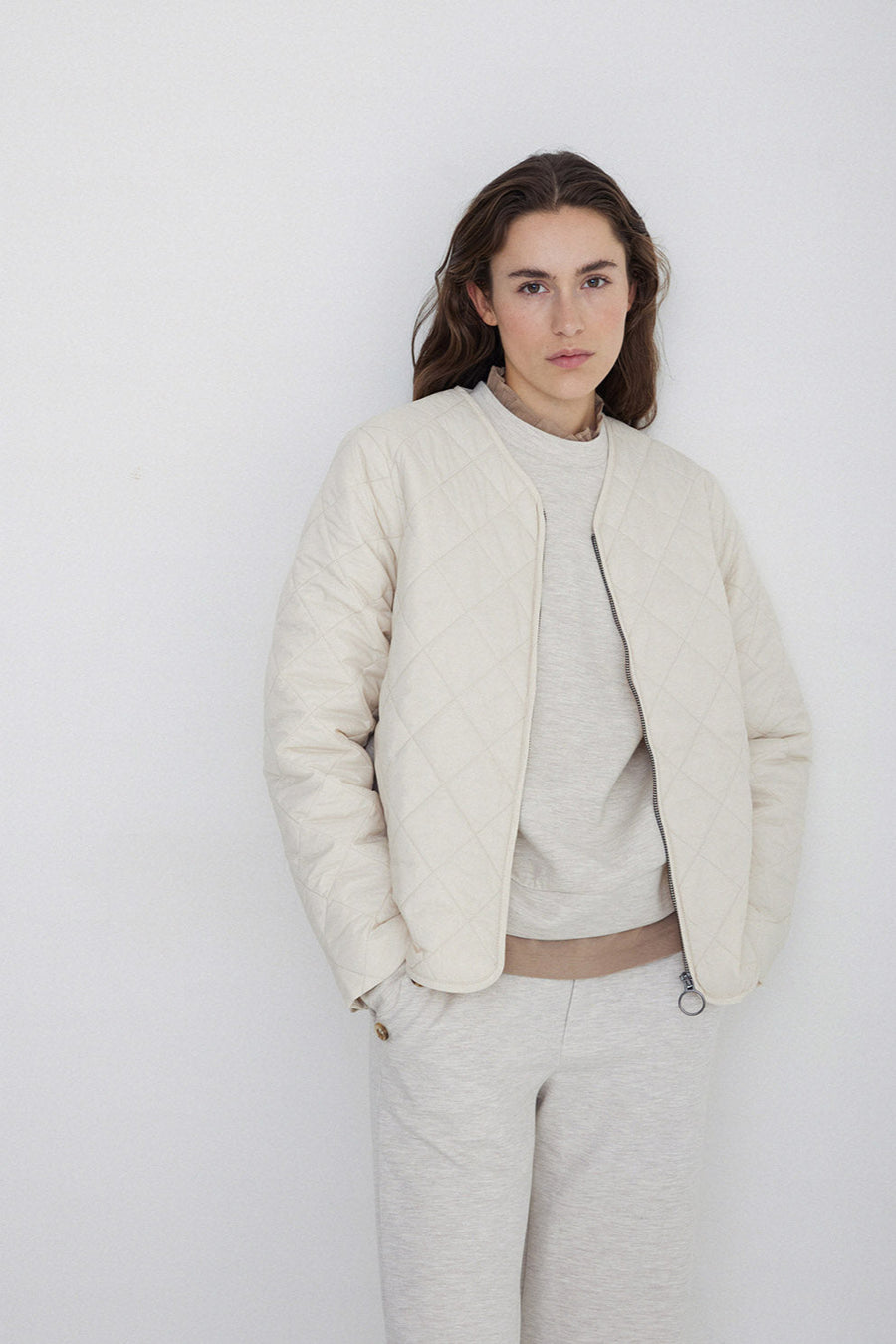 Long sleeve quilted jacket with front zip in natural colour way. 
