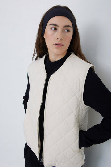 Natural coloured quilted vest with front zip. 