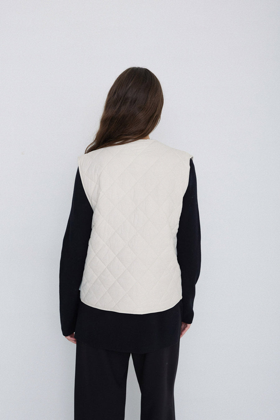 Natural coloured quilted vest with front zip. 