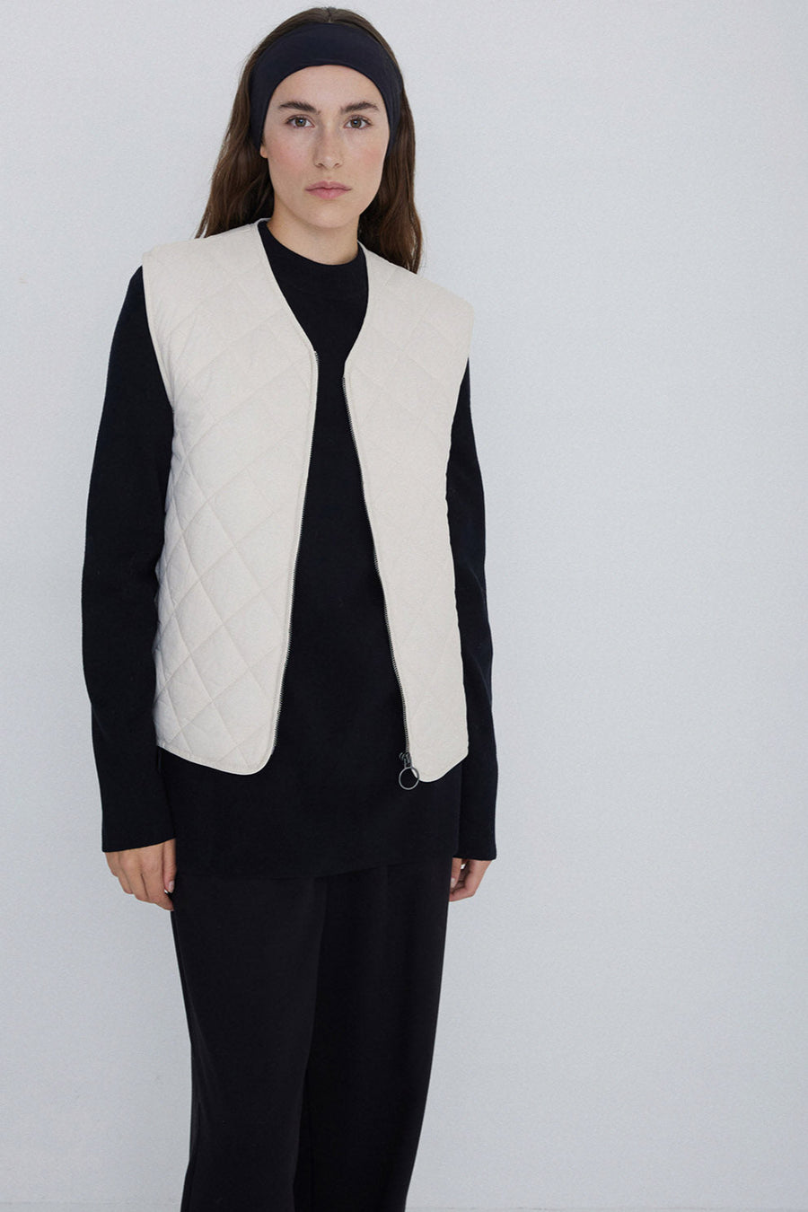 Natural coloured quilted vest with front zip. 