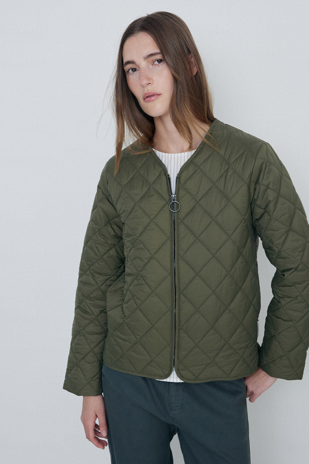 Khaki quilted long sleeve jacket with front zip.