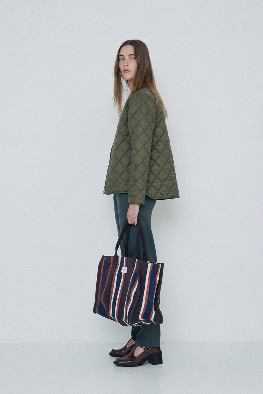 Khaki quilted long sleeve jacket with front zip.