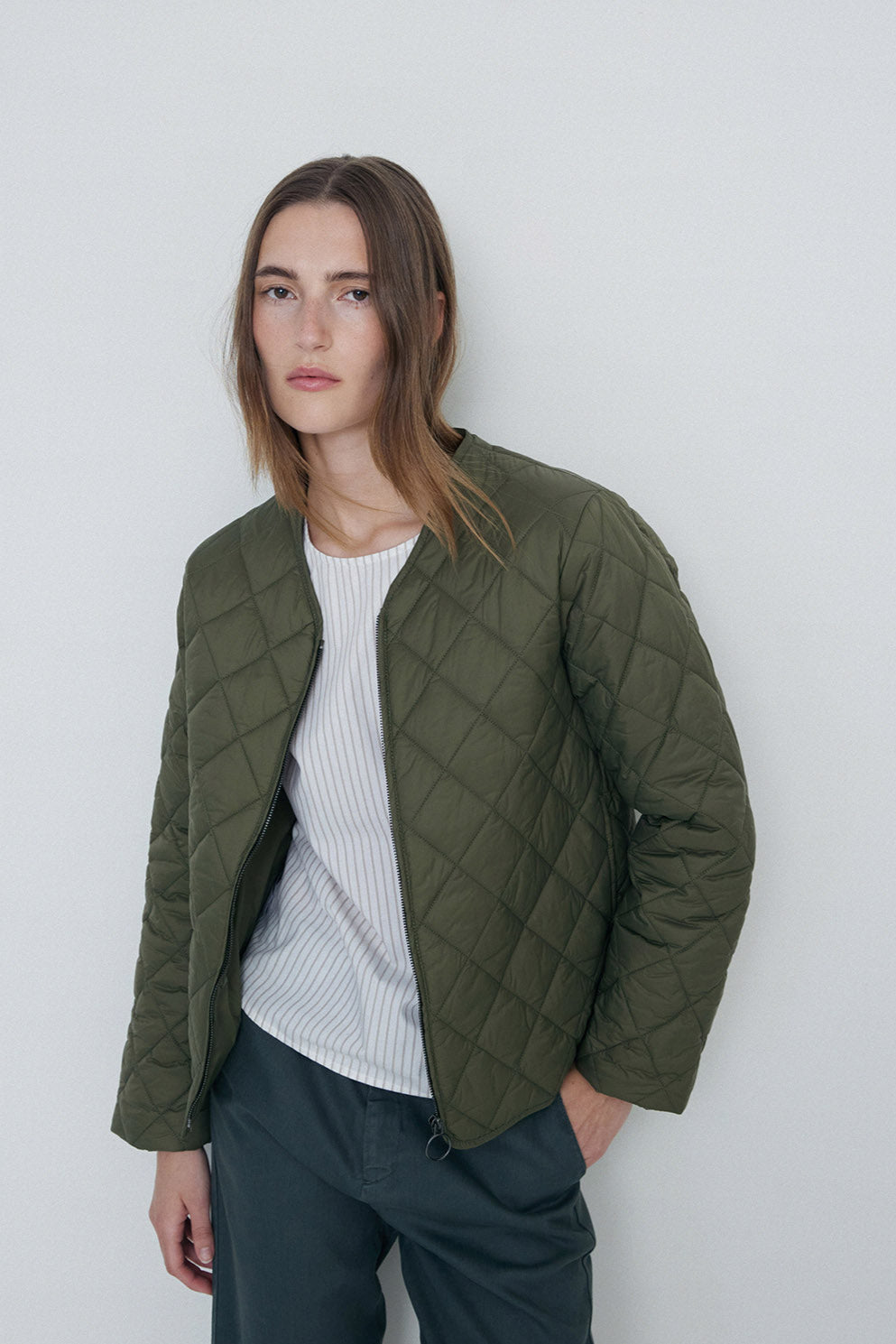 Khaki quilted long sleeve jacket with front zip.