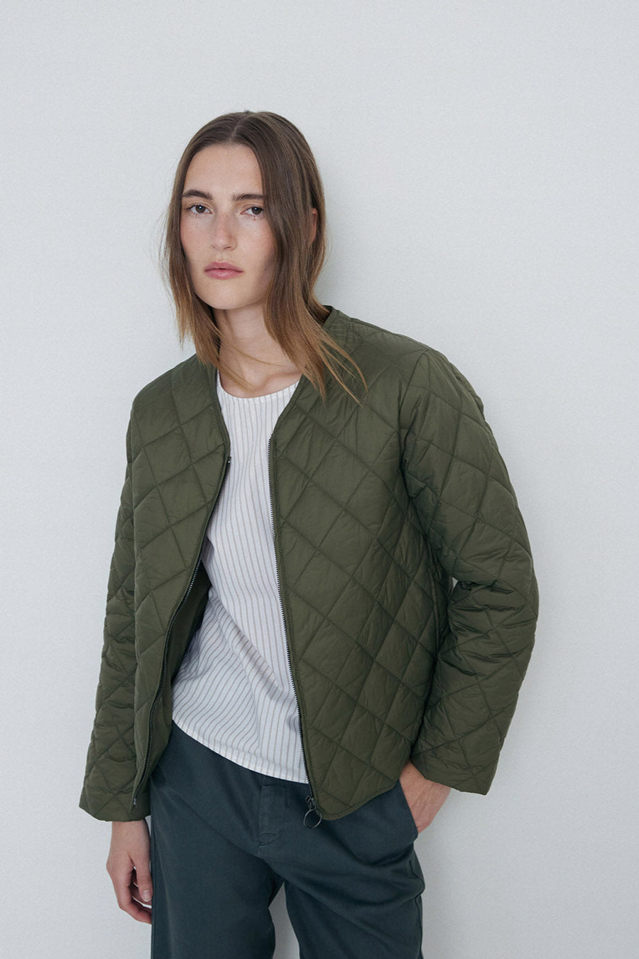 Khaki quilted long sleeve jacket with front zip.