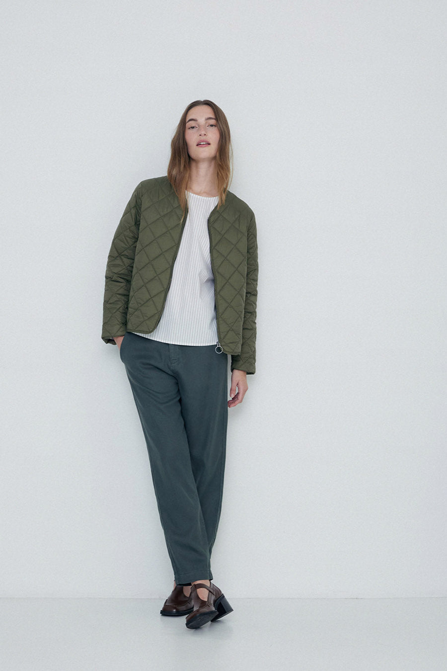 Khaki quilted long sleeve jacket with front zip.