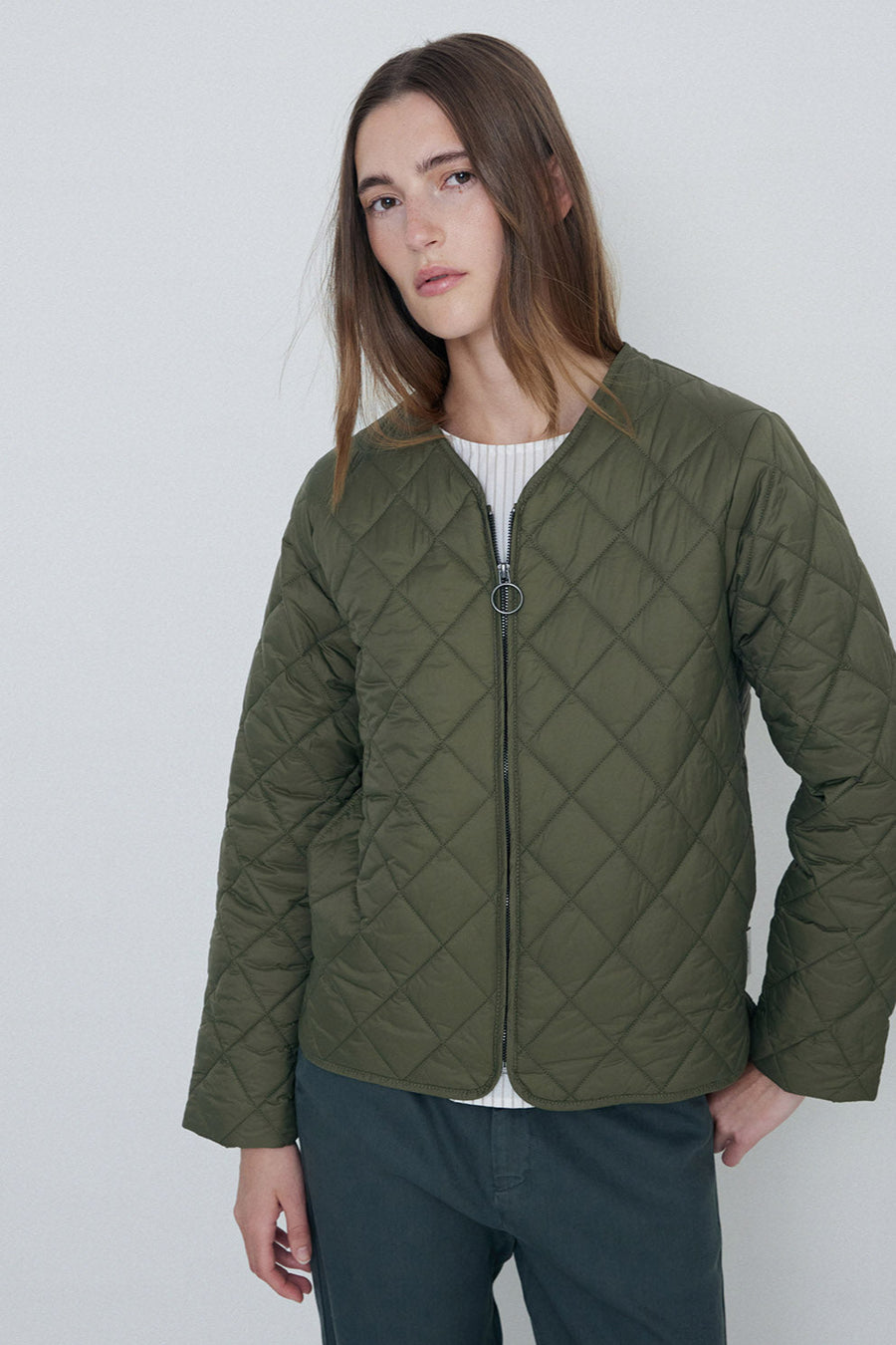 Khaki quilted long sleeve jacket with front zip.